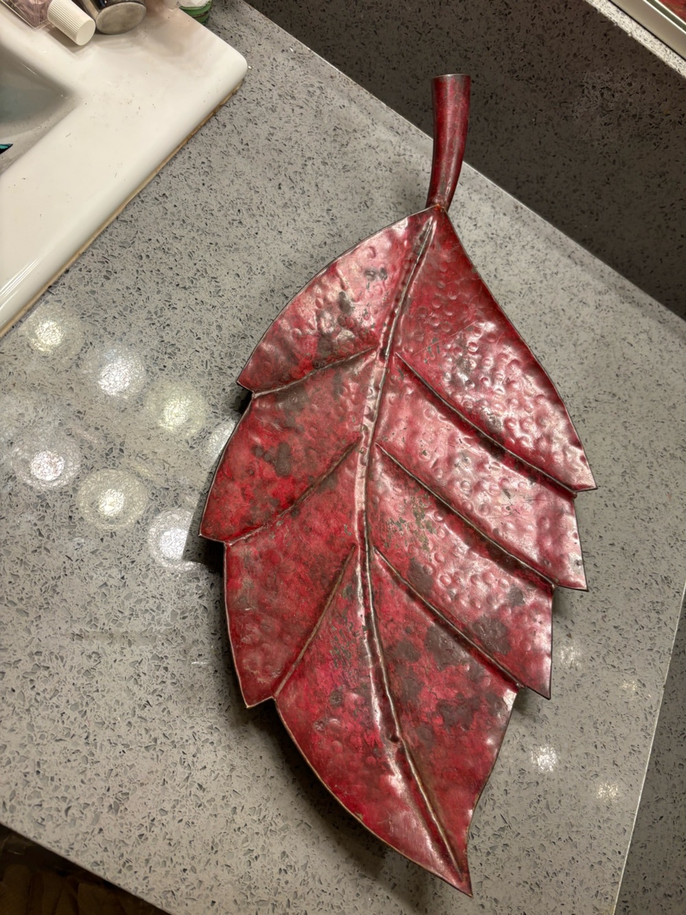 Red Metal Leaf decorative tray that also serves as wall art.